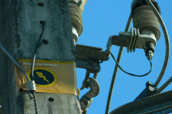a-close-up-of-a-power-pole-with-wires-attached-to-it.jpg A close up of a power pole with wires attached to it